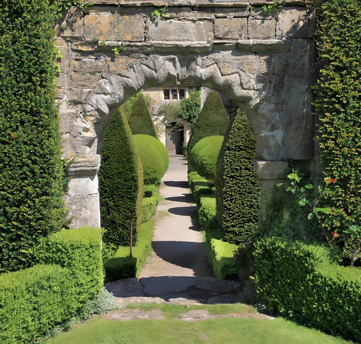 OCUK22937: Brick wall with beautiful arch and some conifers