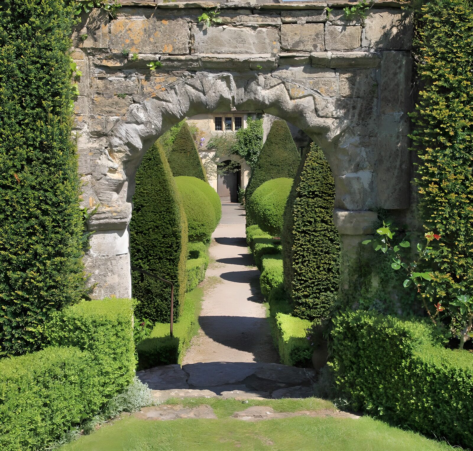 OCUK22937: Brick wall with beautiful arch and some conifers