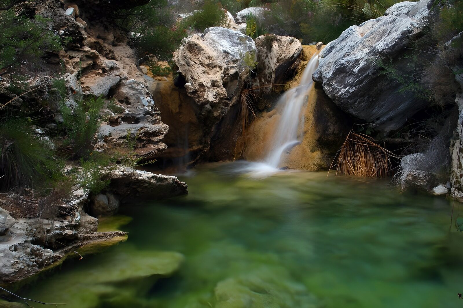 OCUK85252: Tranquil Waterfall in a Rocky Oasis