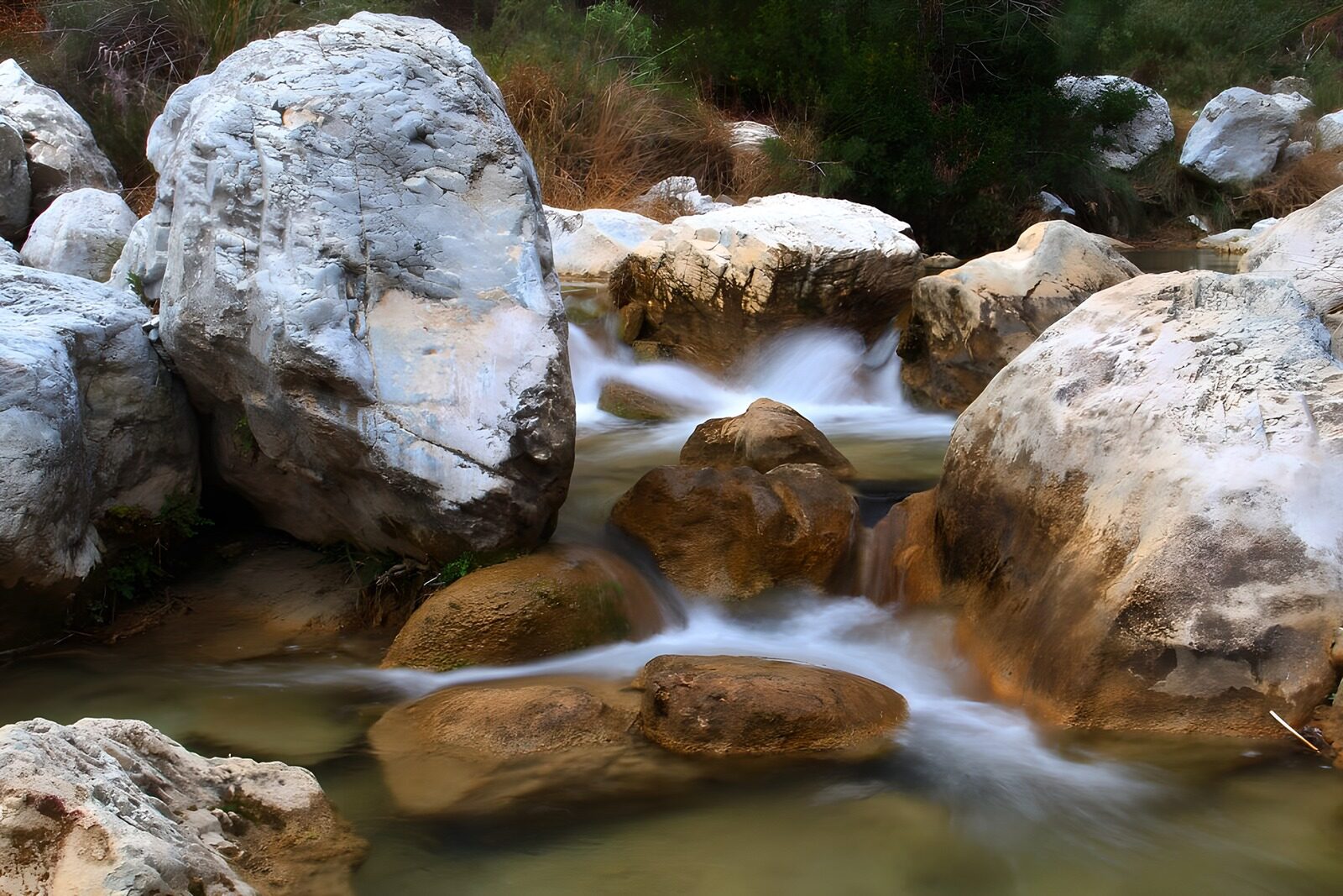 OCUK37224: Serene Stream Among Rocky Outcrops