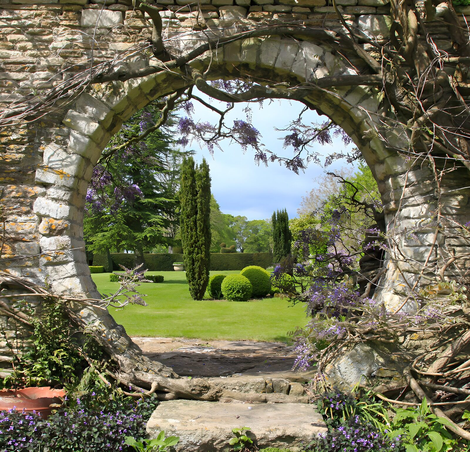 OCUK18508: Tranquil Garden View Through Stone Arch