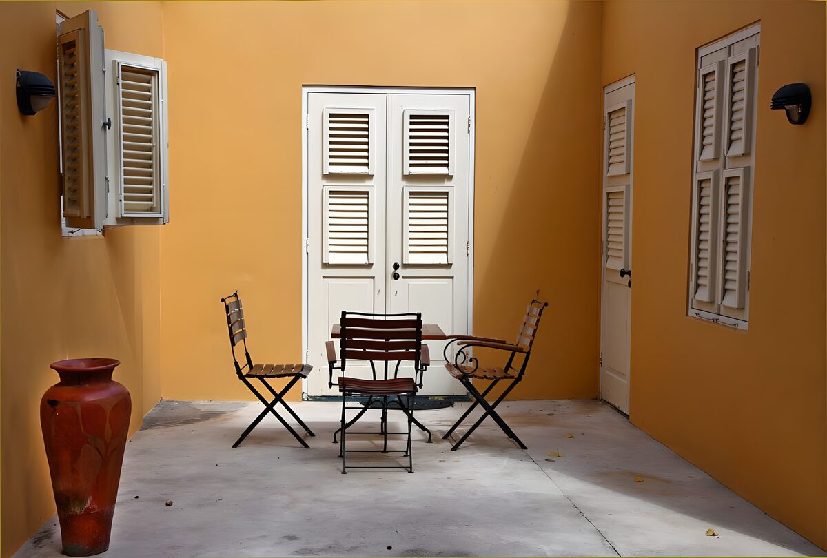 Patio wirth yellow walls and table and chairs