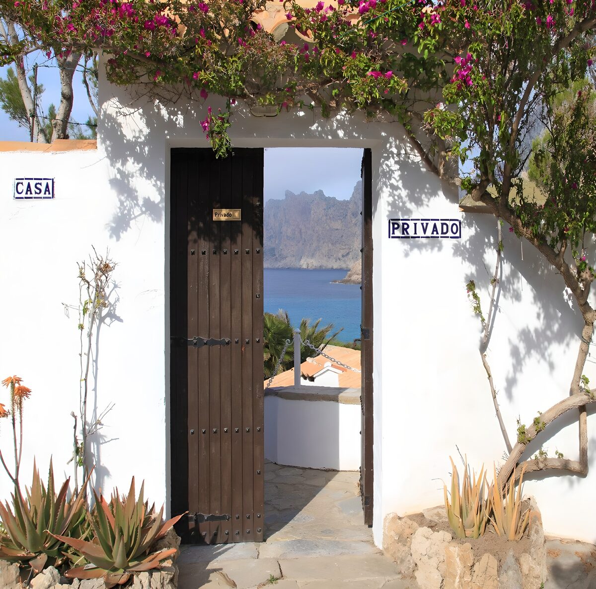 White wall with pen door and view on Mediterranean Sea