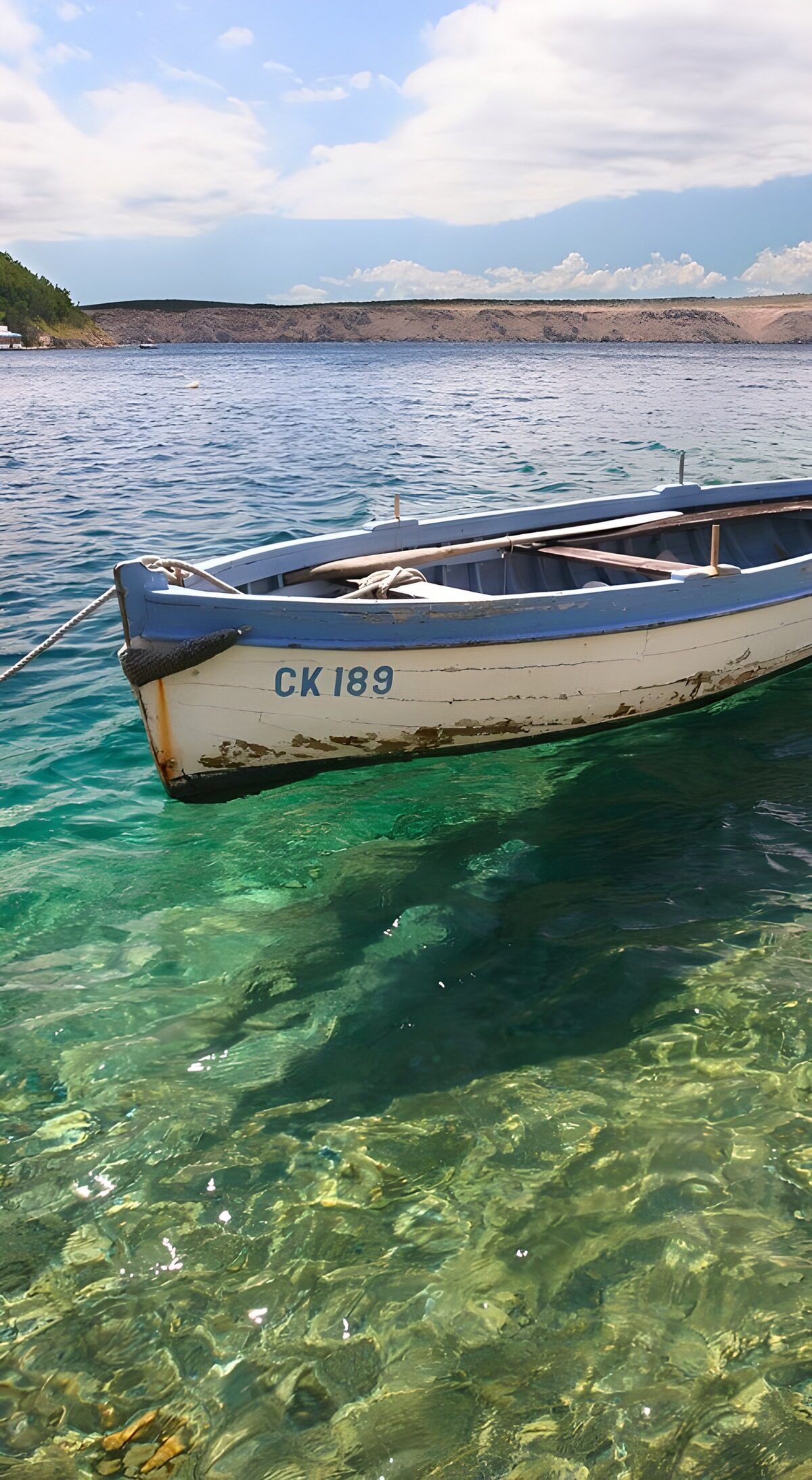 OCUK22462: Tranquil Waters and a Weathered Boat