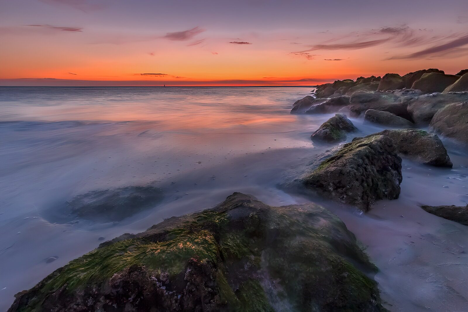 OCUK72540: Serene Sunset Over Rocky Shoreline