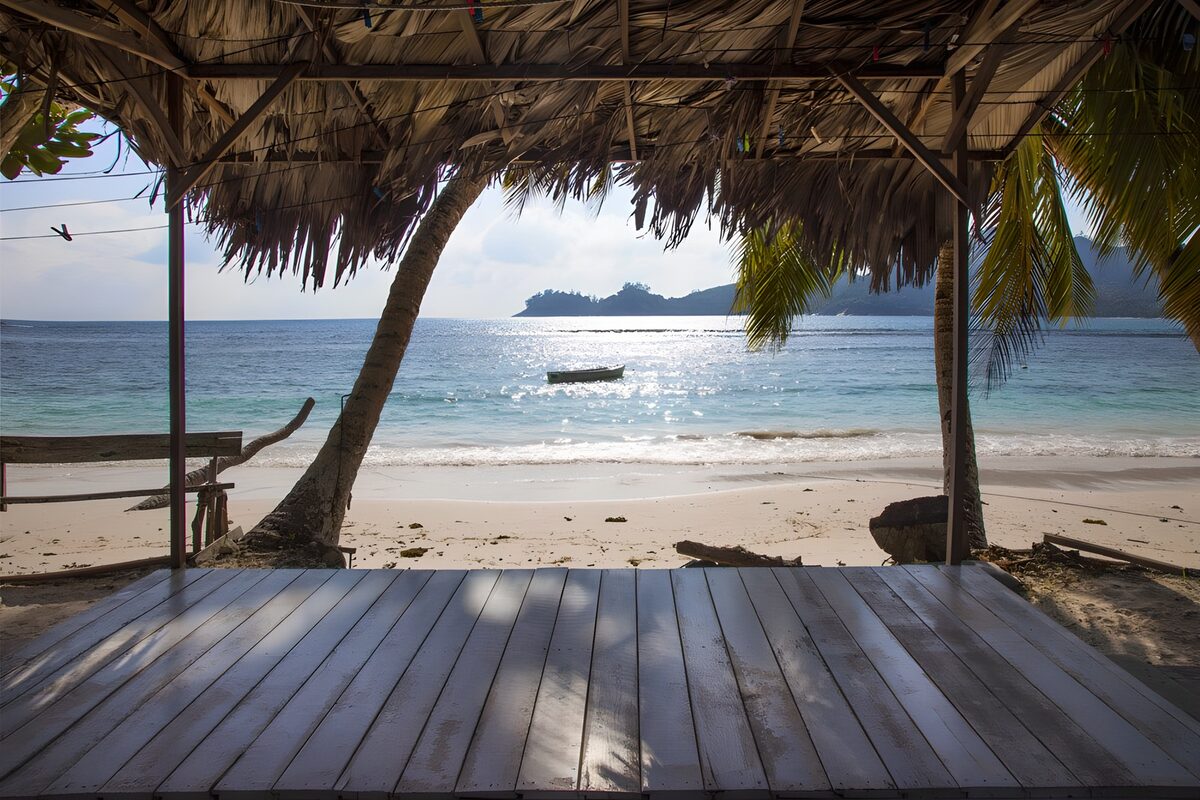 Wooden footbridge with thatched roof overlooking the Indian Ocean