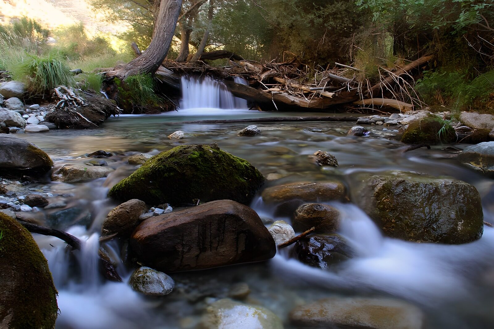 OCUK80975: Serene Stream Flowing Through Rocky Landscape