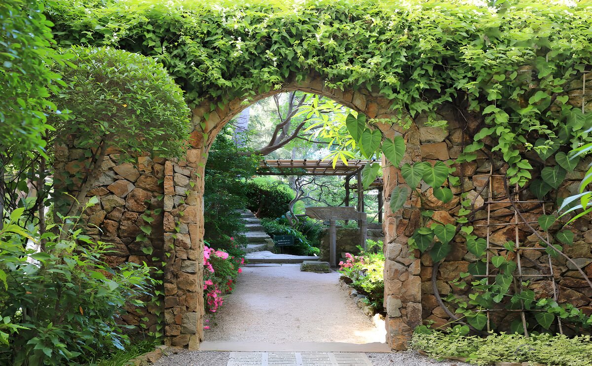 Garden poster with old wall and passage to Japanese garden