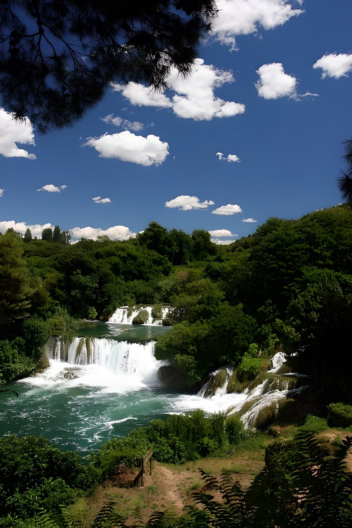 OCUK73307: Serene Waterfall Beneath a Blue Sky