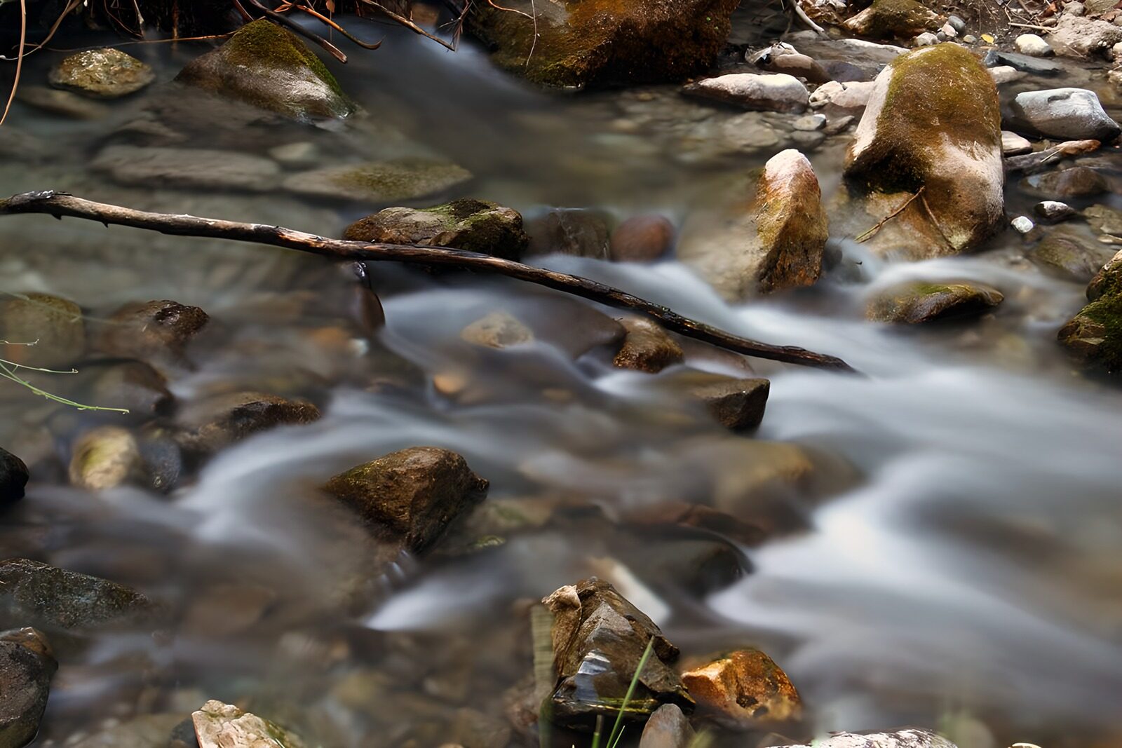 OCUK51033: Serene River Flow Among Smooth Stones