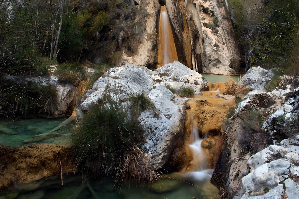 OCUK32781: Serene Cascades in a Rocky Landscape