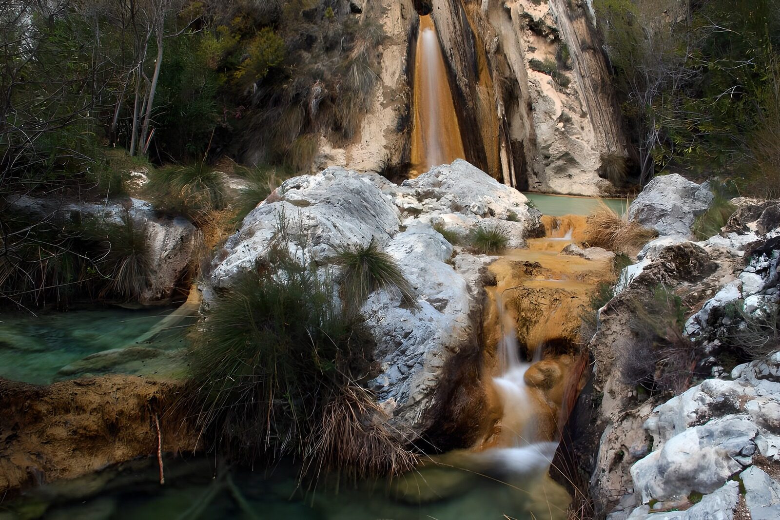 OCUK32781: Serene Cascades in a Rocky Landscape