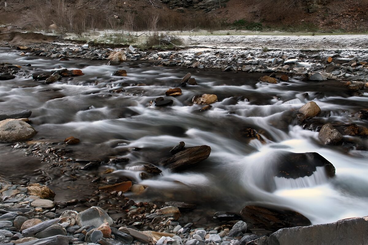 OCUK64704: Serene River Flowing Over Rocks