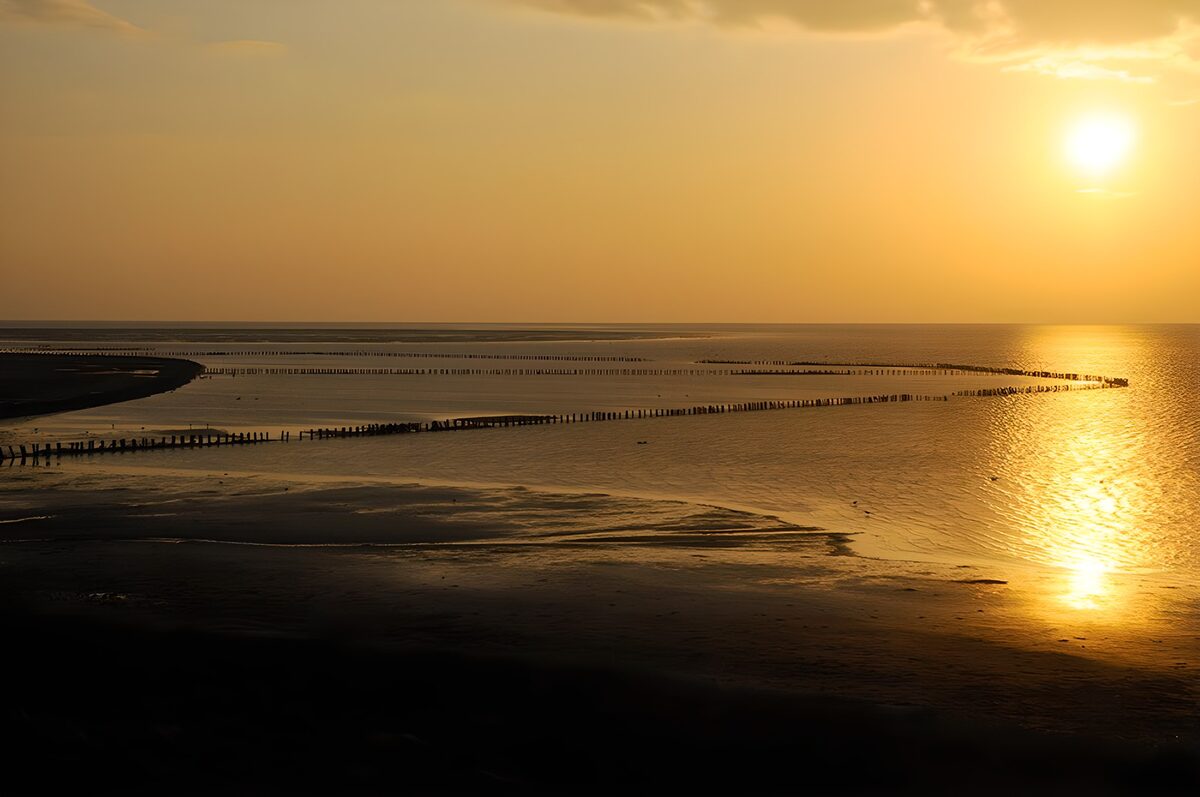 Serene Sunset Over Curved Shoreline