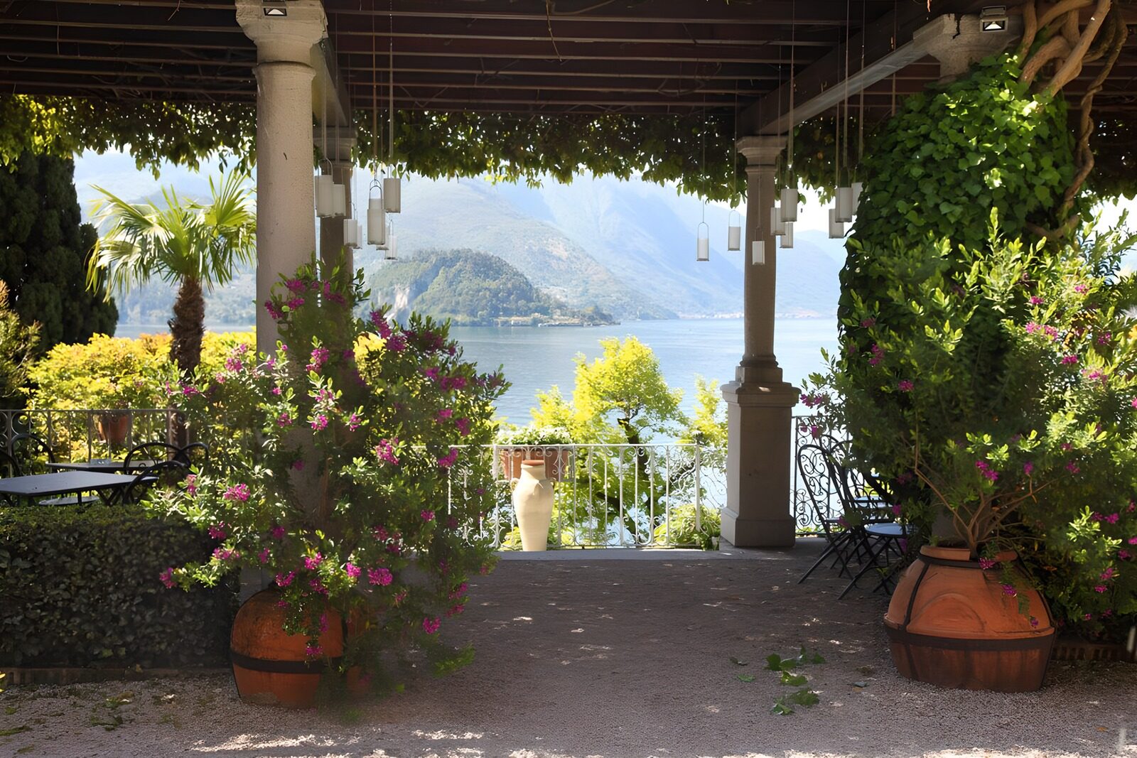 OCUK21126: Sun shade covered terrace with flowerpots and view to ocean
