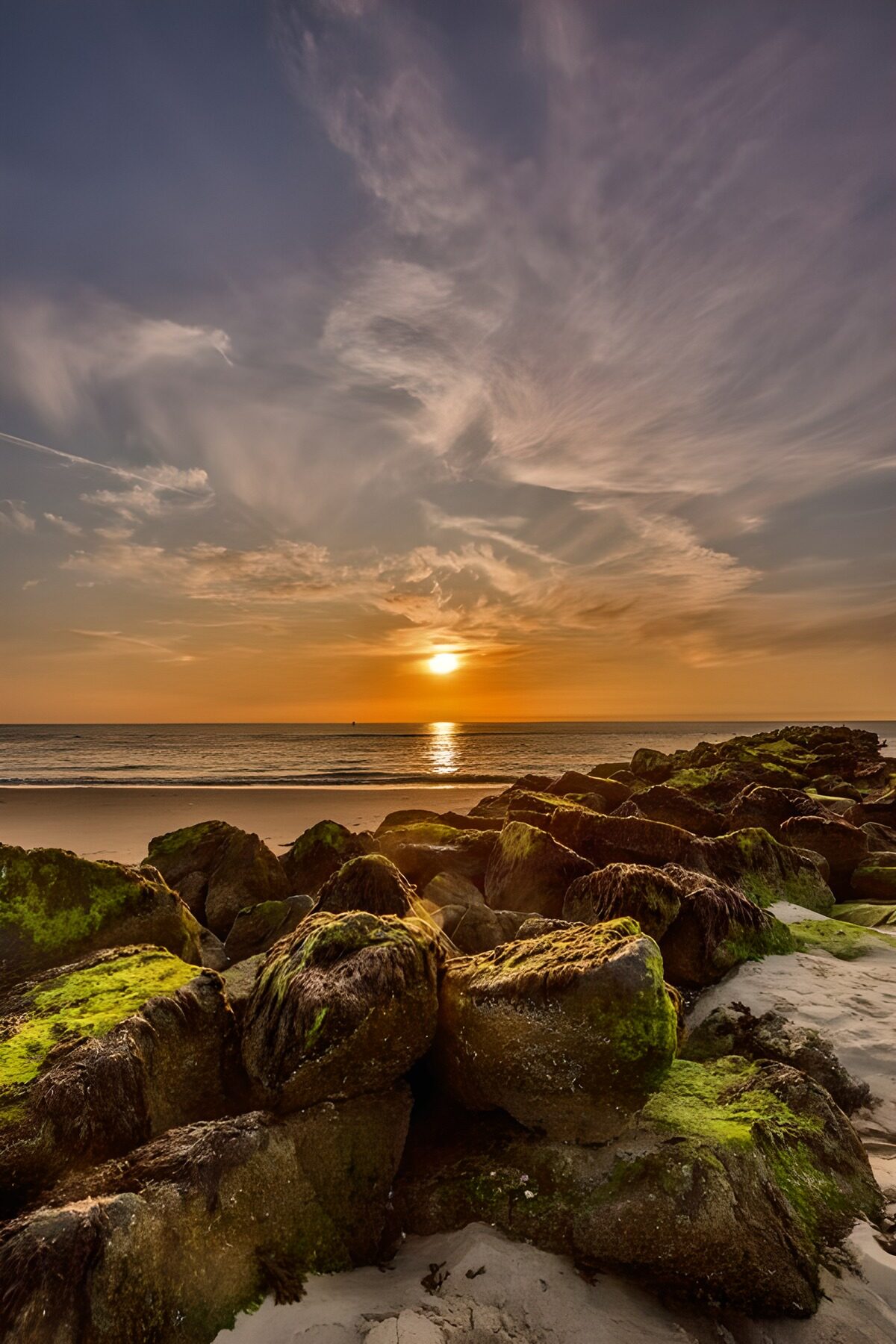 OCUK94078: Serene Sunset Over Rocky Shoreline