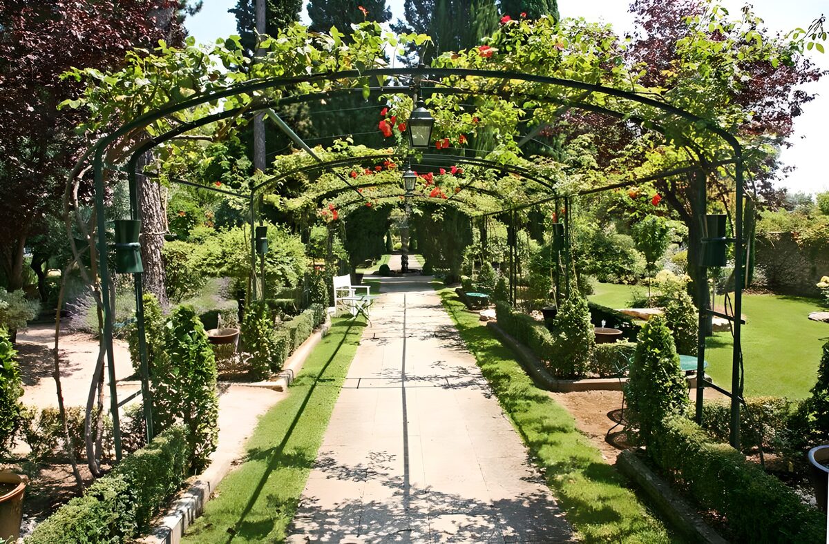 View through rose arch in French garden version 3