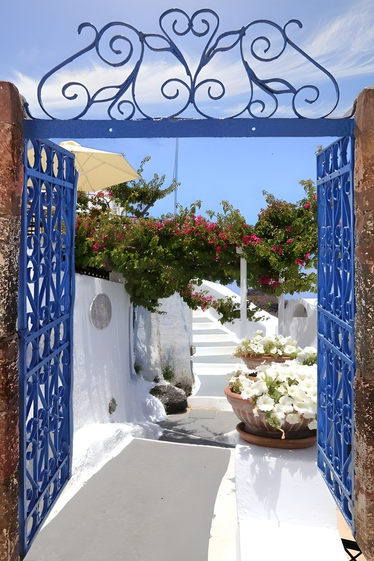OCUK56985: "Charming Blue Gate to a Sunlit Garden"