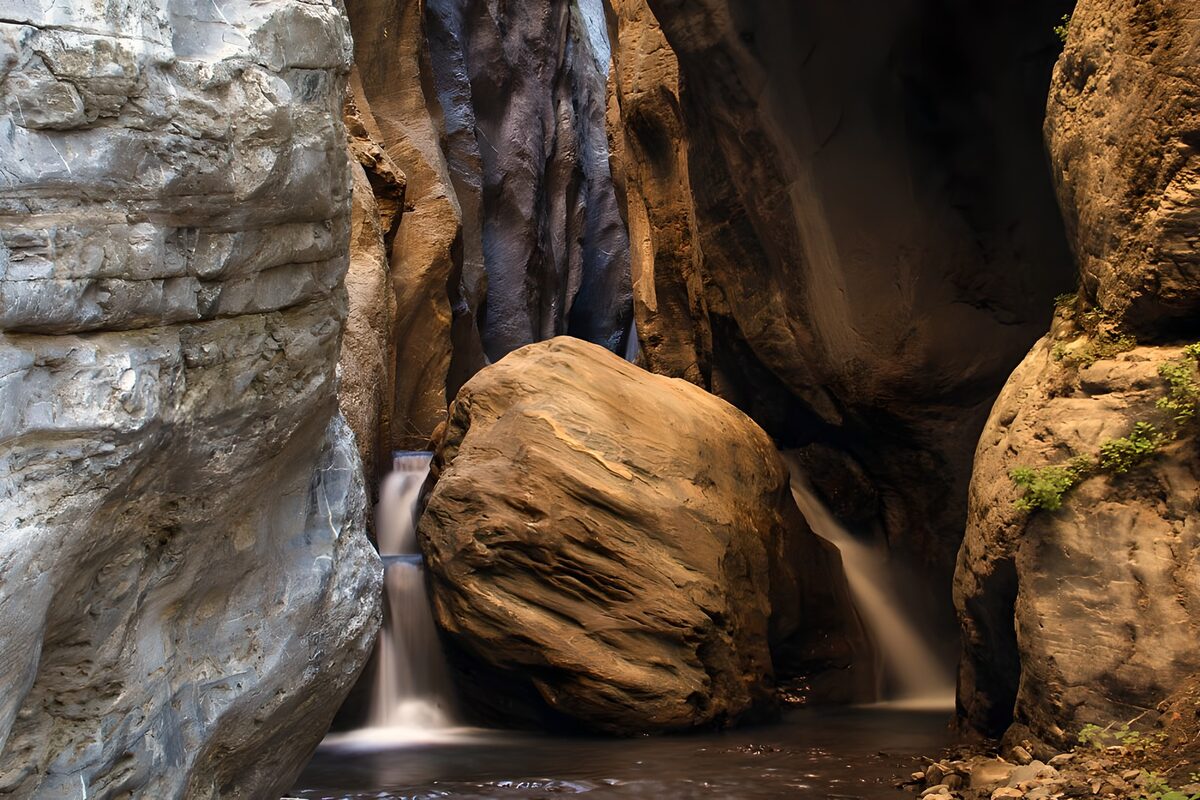 OCUK66333: Serene Rock Formation with Waterfall