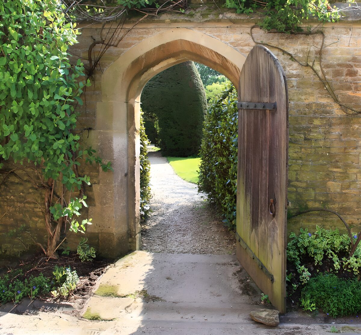 OCUK66197: Old brick wall with a wooden gate and an entry to a garden