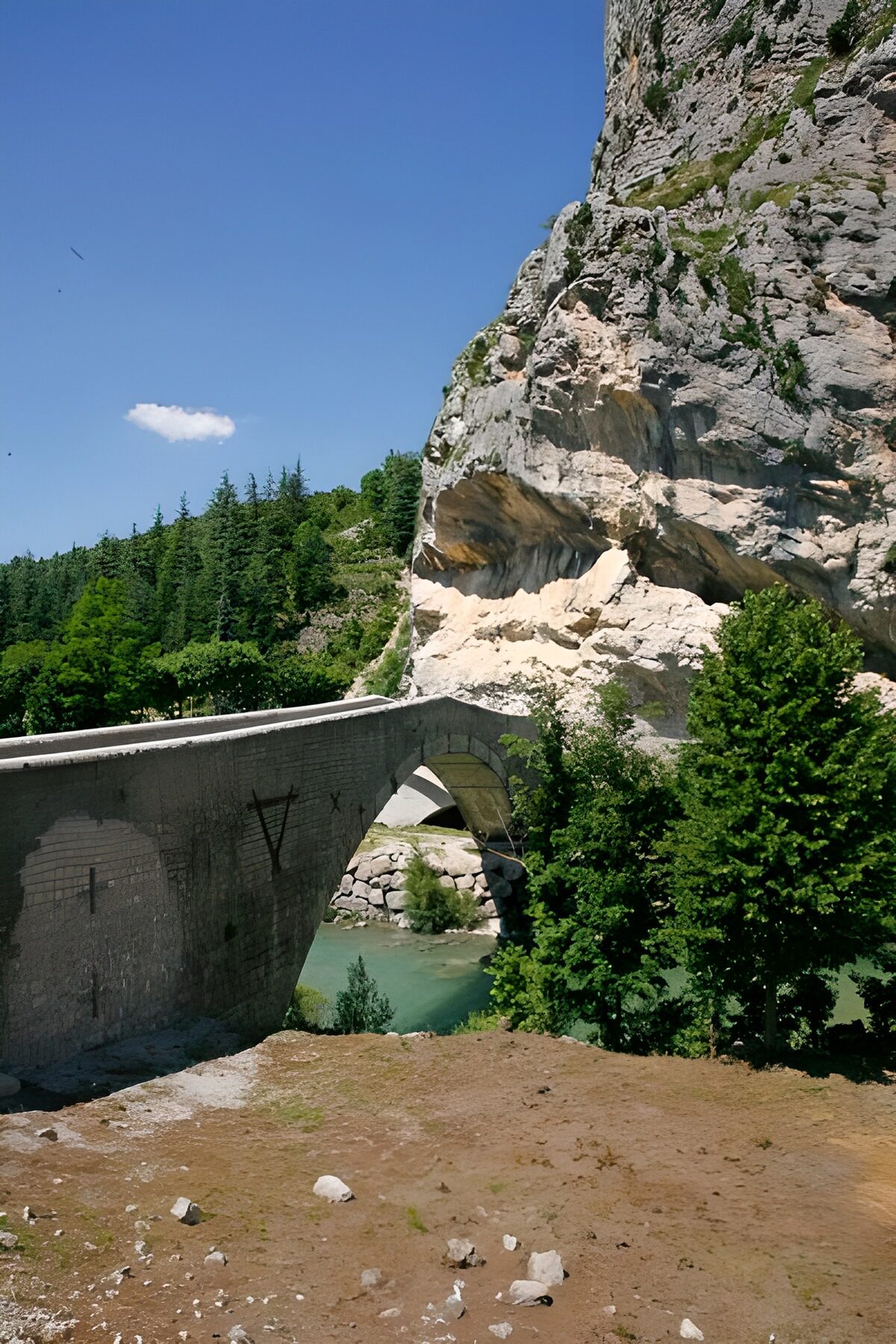 OCUK25877: Arched bridge over mountain river