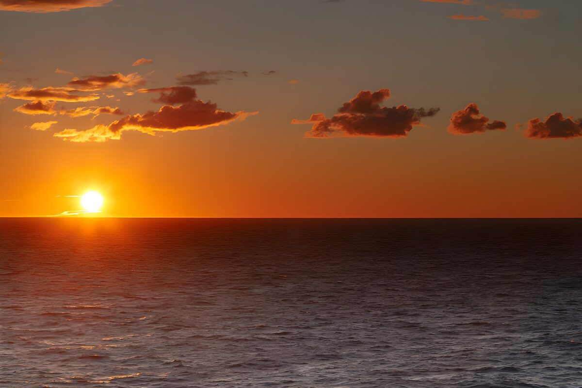 OCUK52094: Sunset Over the Calm Ocean Waters