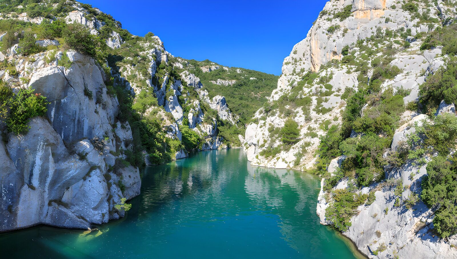 OCUK86262: Serene River Flowing Through Rocky Cliffs