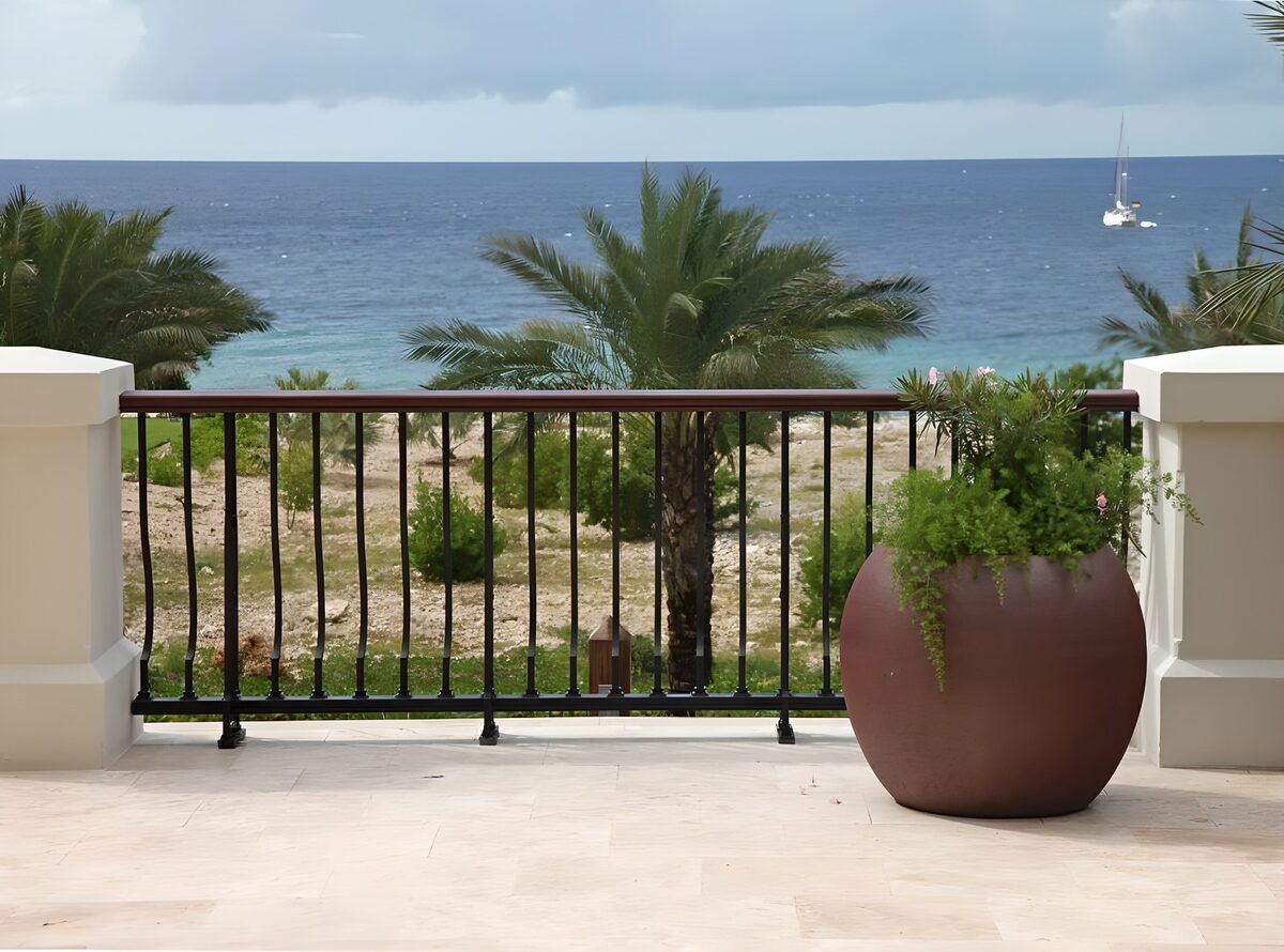 OCUK80512: Flowerpot with plant with a view over the Caribbean and catmaran