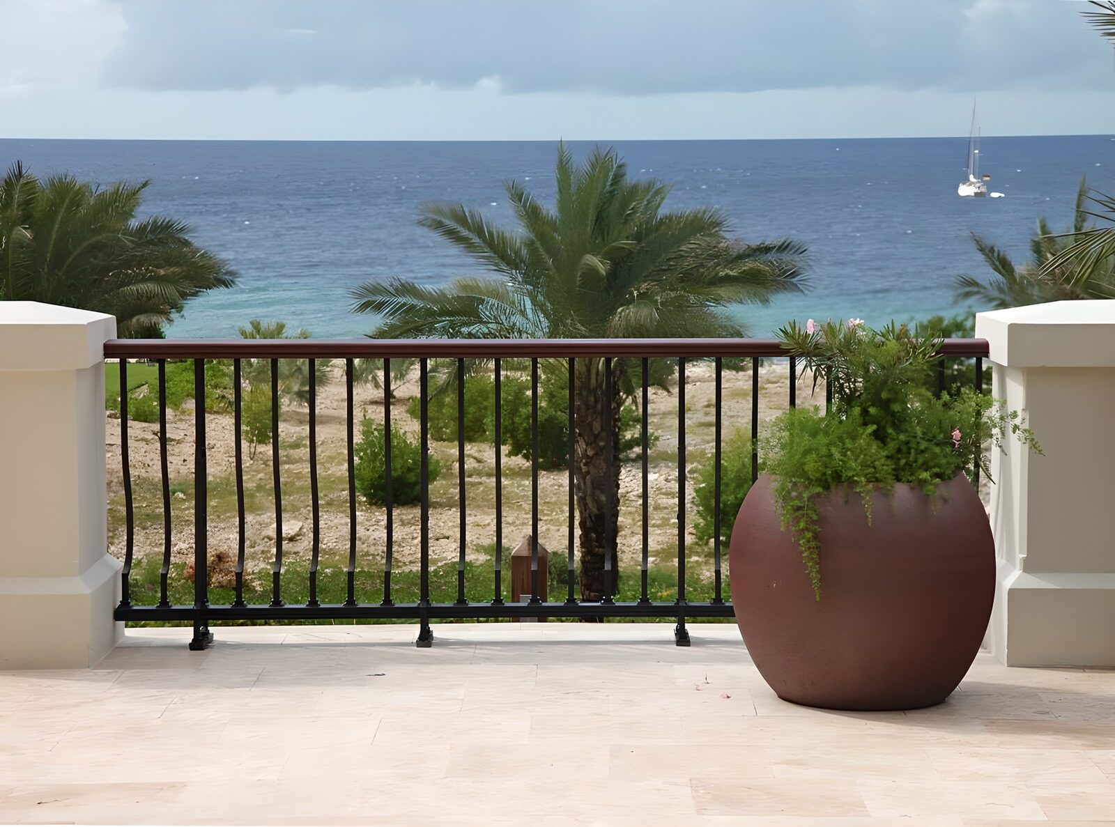 OCUK80512: Flowerpot with plant with a view over the Caribbean and catmaran