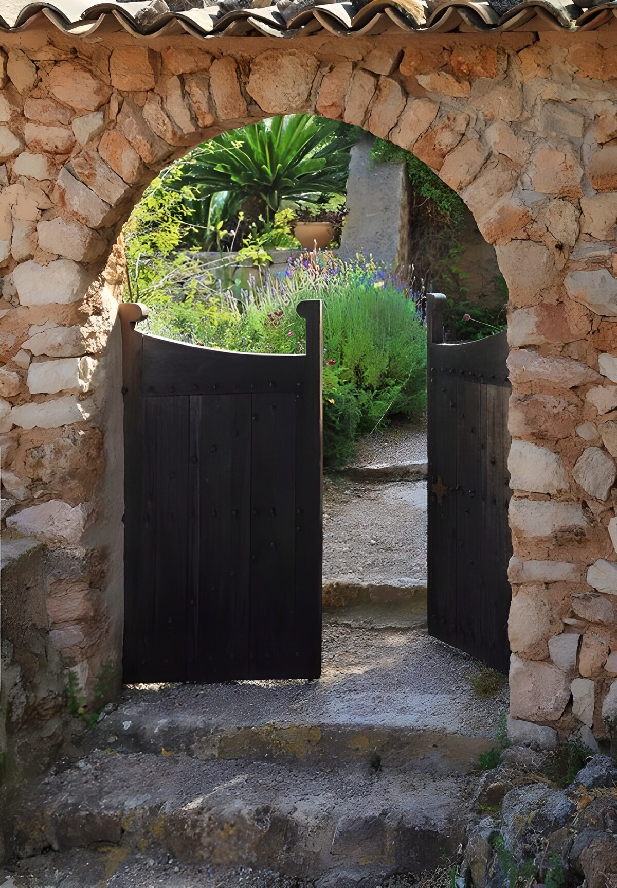 OCUK32268: Dark double wooden door in a old arched brick wall