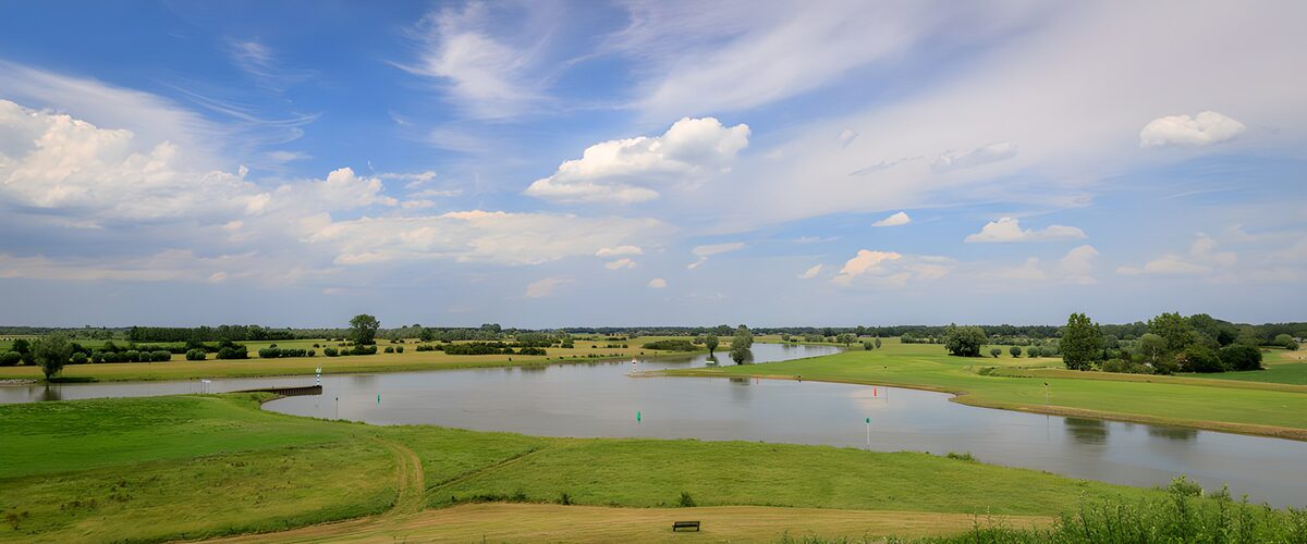 OCUK58800: Tranquil River Landscape Under Blue Skies