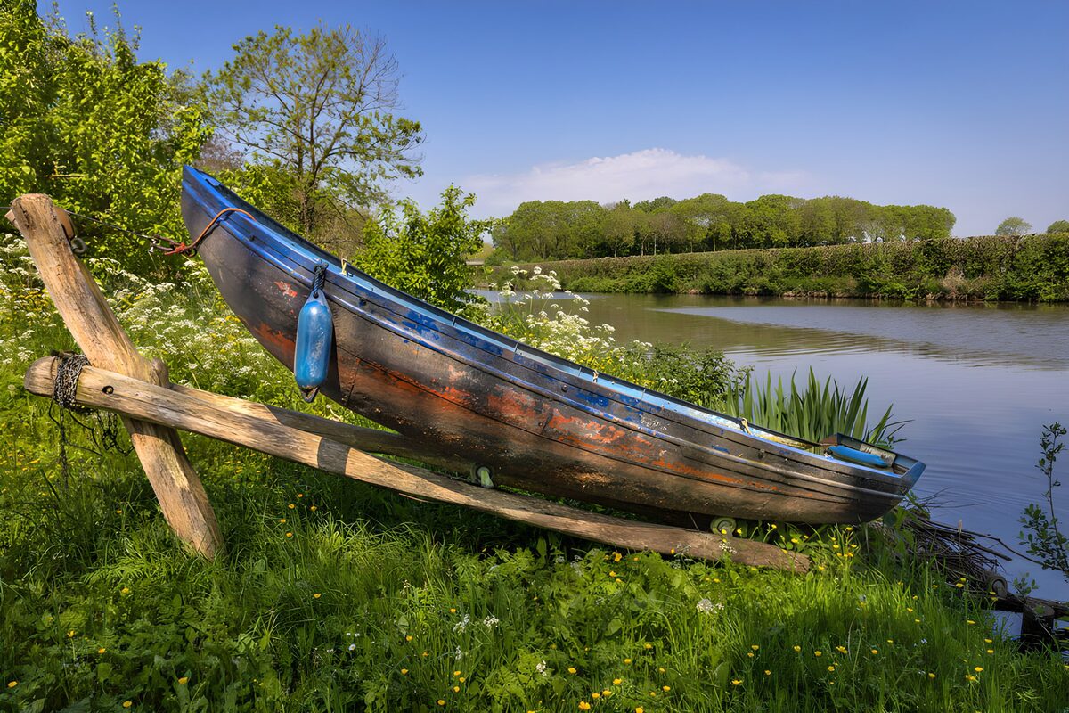 OCUK41643: Tranquil Riverbank with Old Boat