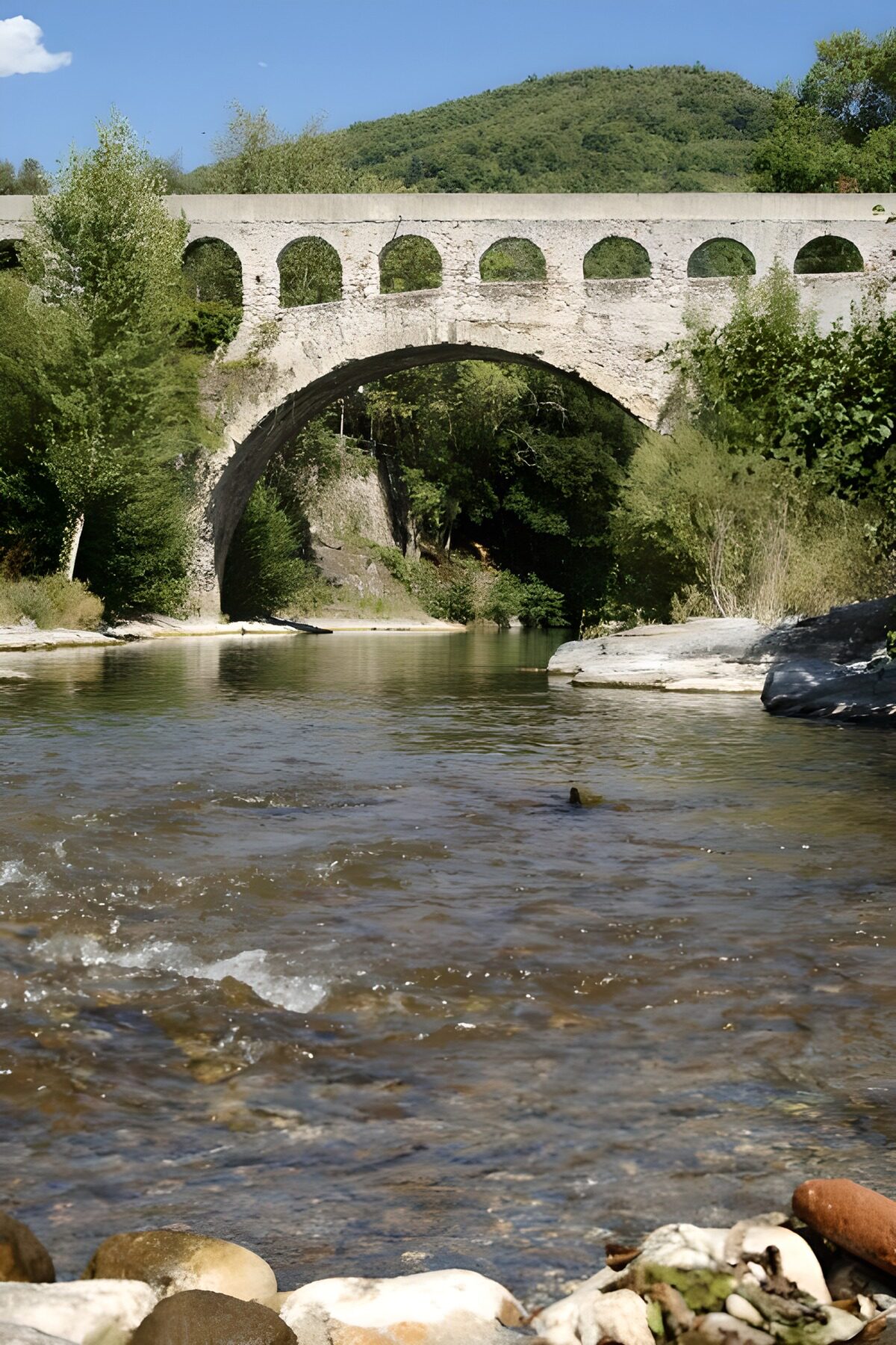 OCUK38898: Tranquil River Under an Arched Bridge