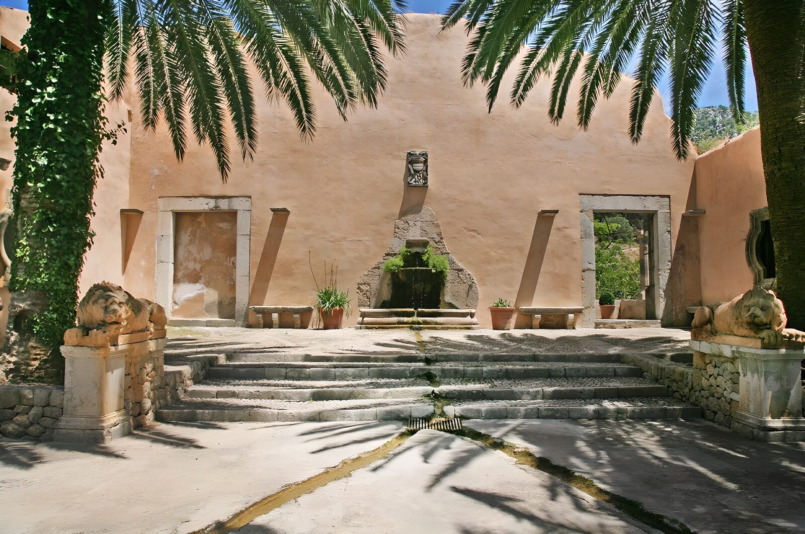 OCUK37458: View towards orangy wall with fountain , palm trees and statues