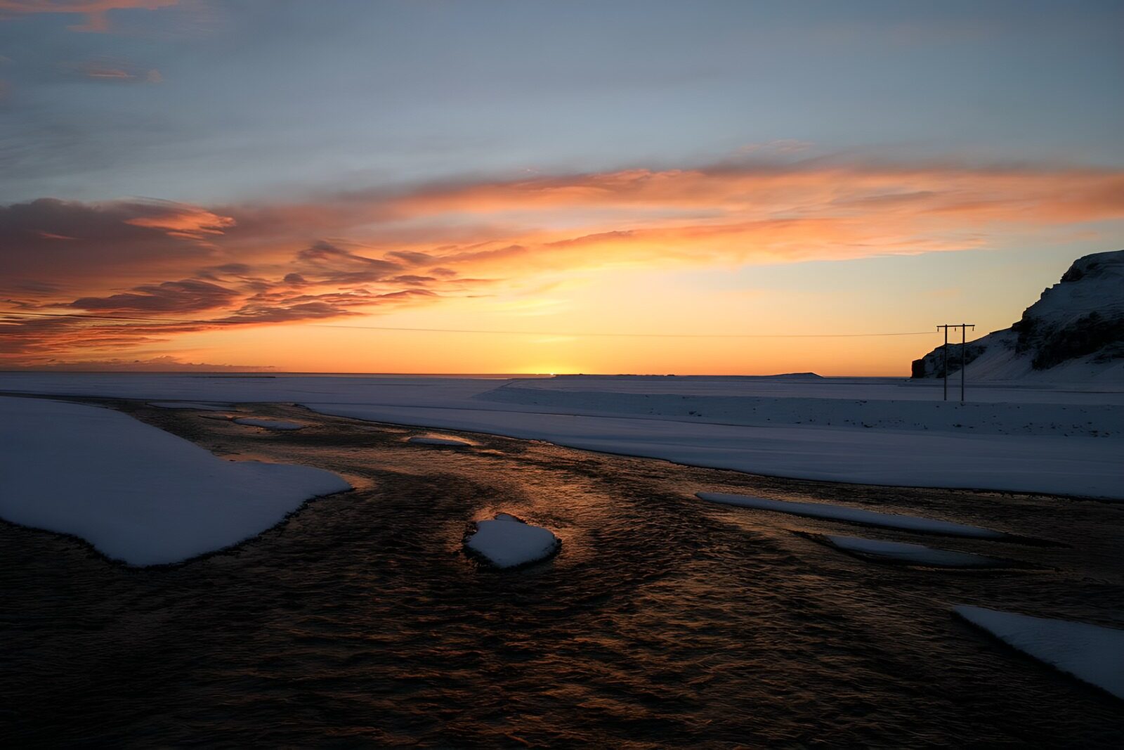 OCUK75920: Serene Winter Sunset Over Frozen Landscape