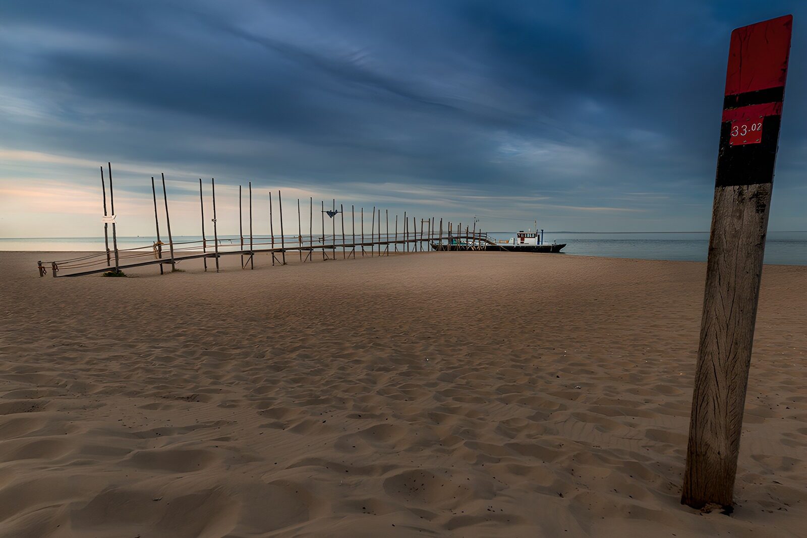 OCUK12482: Tranquil Beach with Fishing Dock