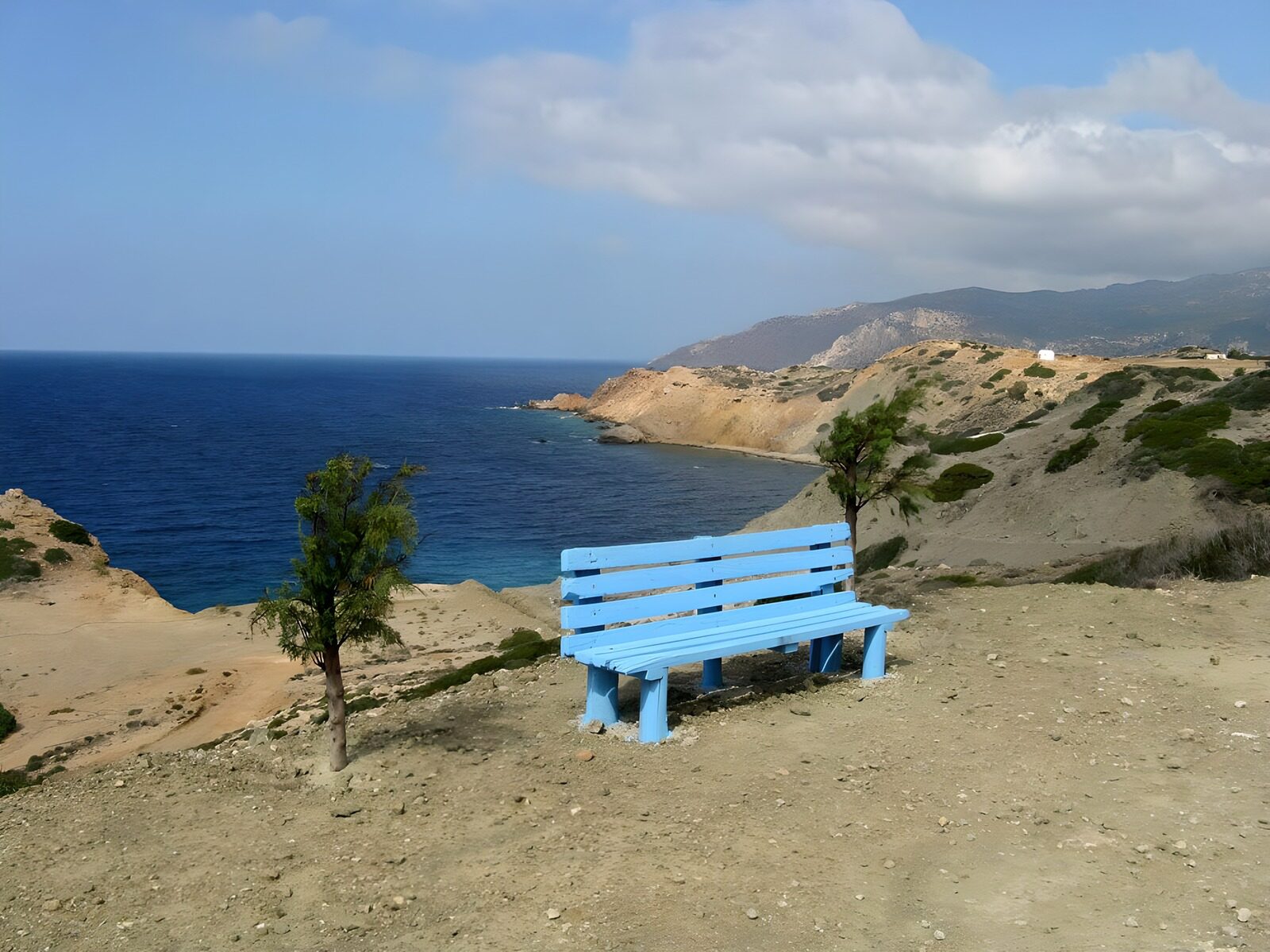 OCUK94052: Blue bench with view on rocks in the sea