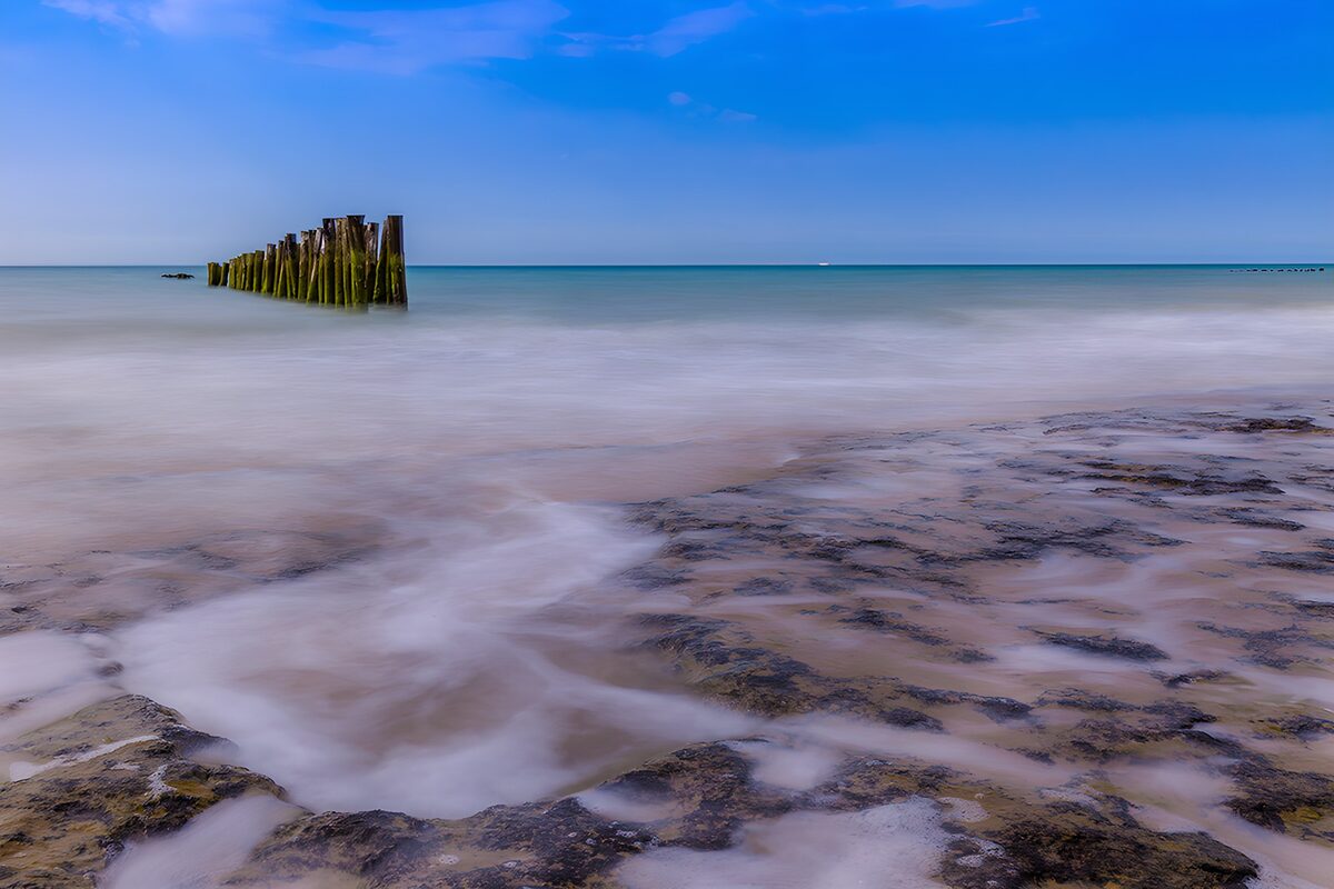 OCUK52168: Serene Beach and Weathered Piers