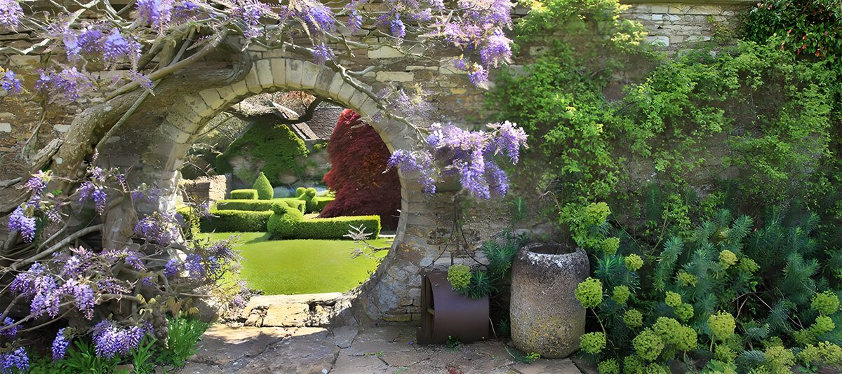 Round entry with Wisteria Sinensis and a lookout at an English garden
